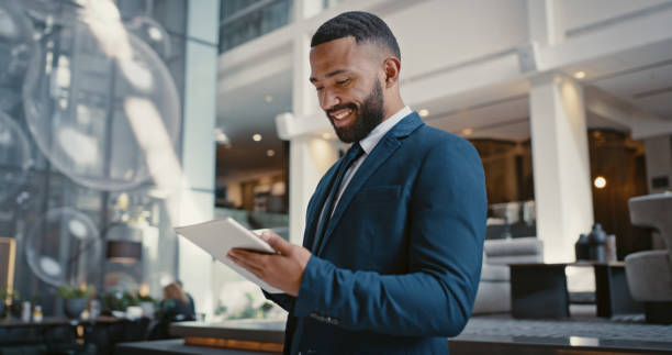 bg-3 Businessman, digital tablet or strategy planning in hotel conference lobby or airport travel lounge. Happy smile, corporate worker or technology app to budget company finance or schedule target goals